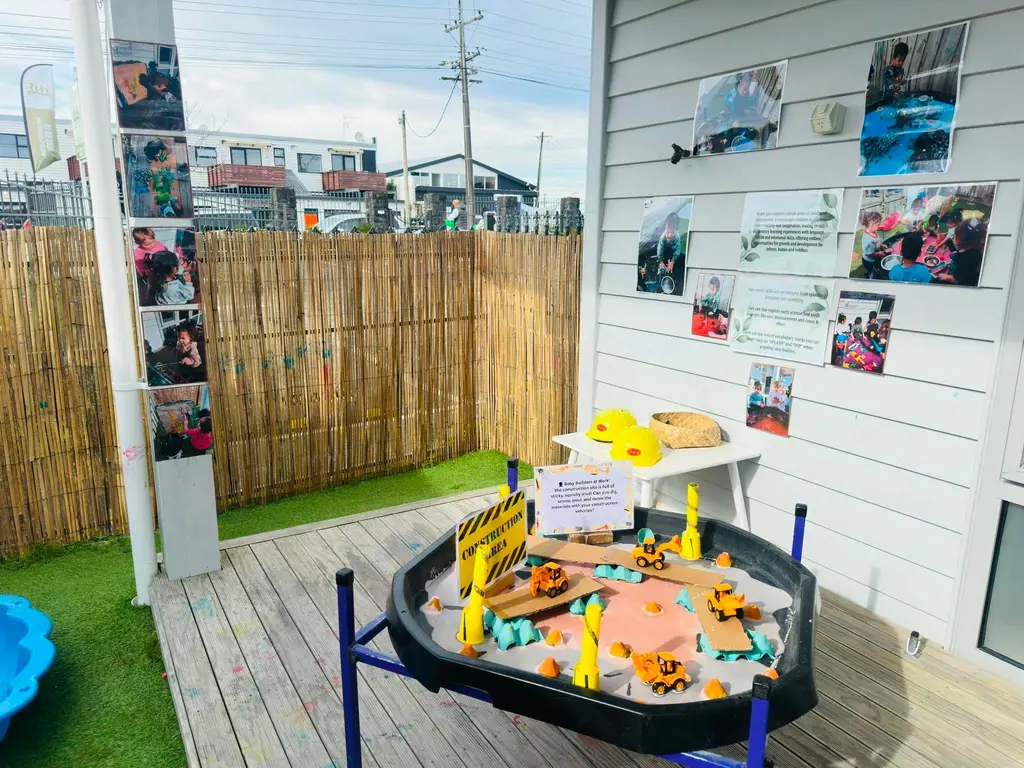 Covered outdoor play area with a small-world activity table
