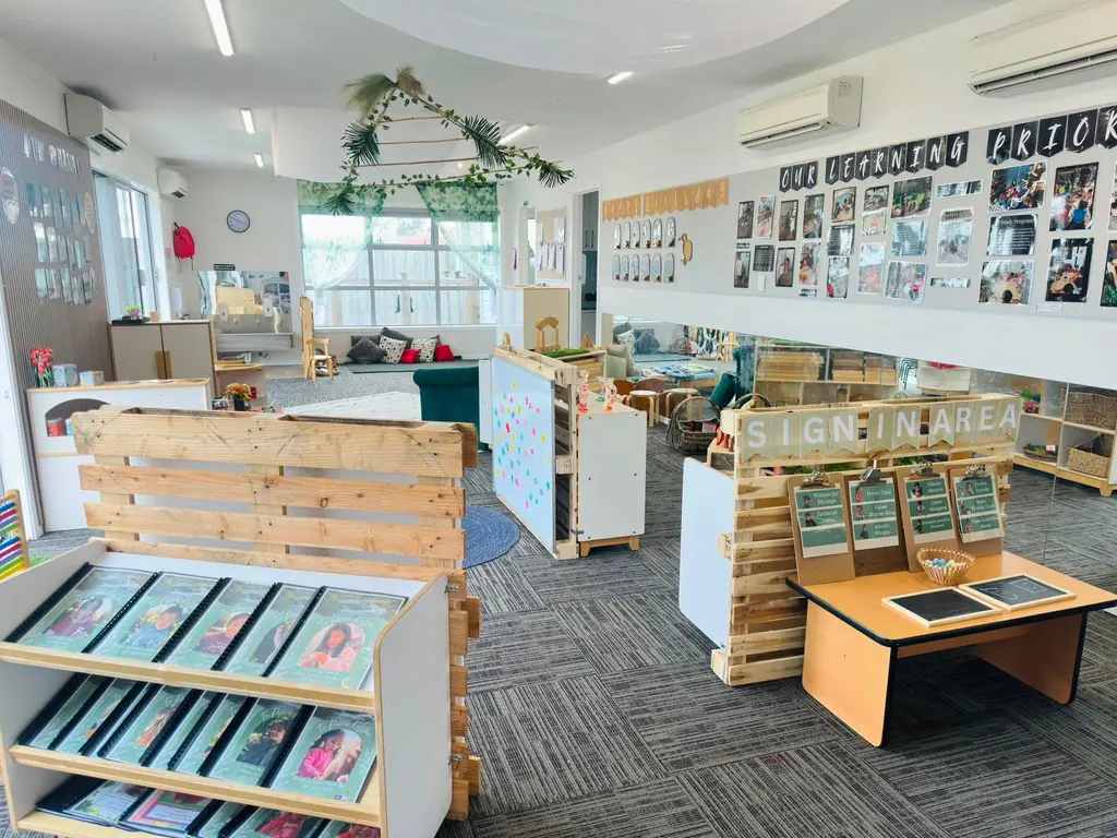 Open learning space with books, activity tables, and low shelves