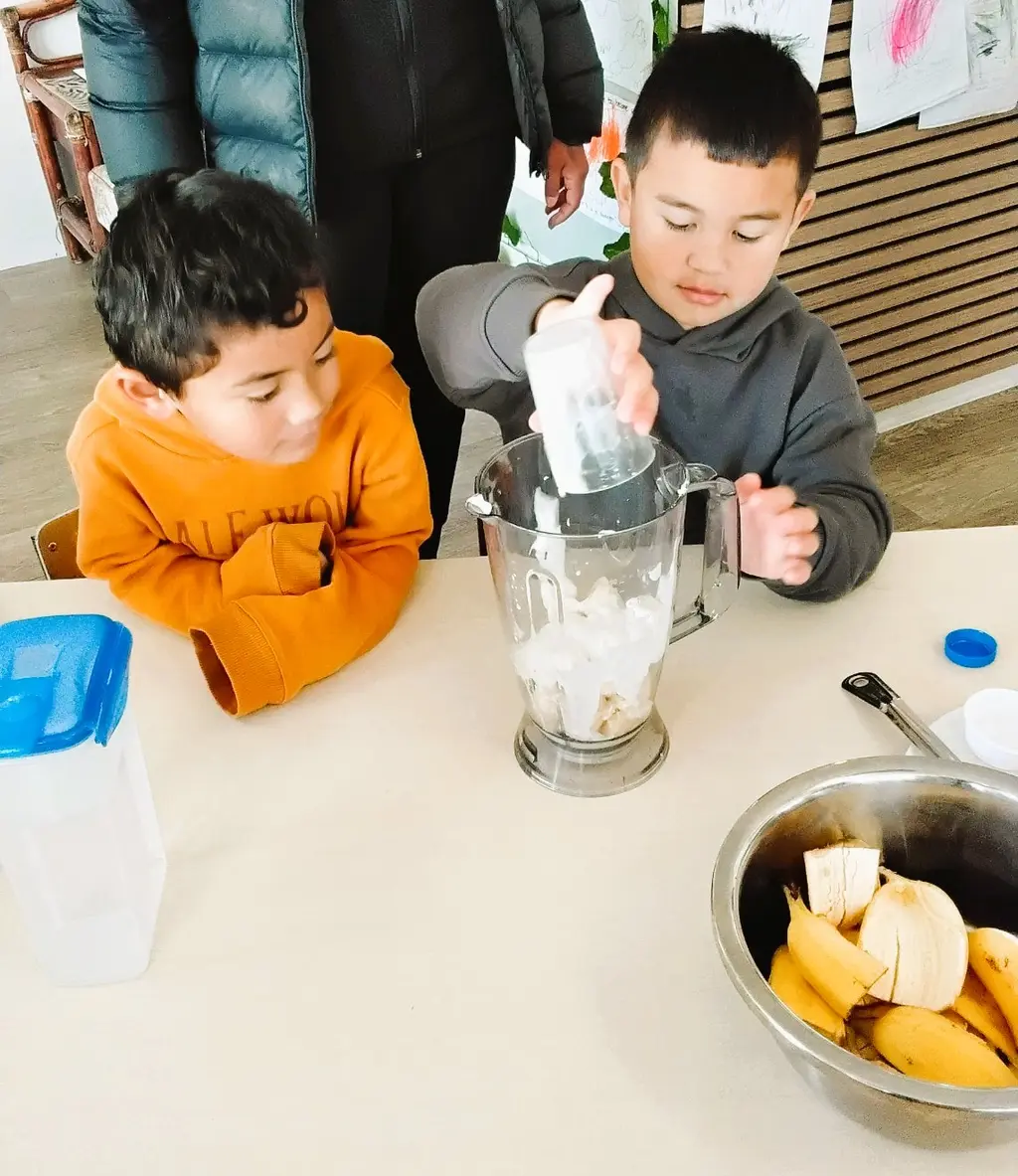 Children watching a blender during a food preparation activity