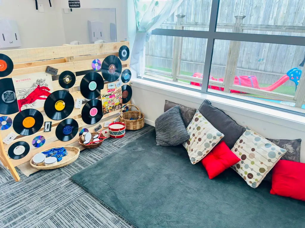 Cushioned gathering space beside a music display