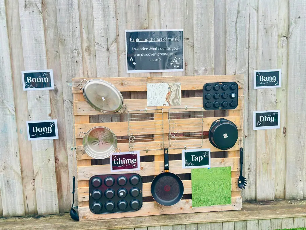 Outdoor music wall with pots, pans, and percussion objects