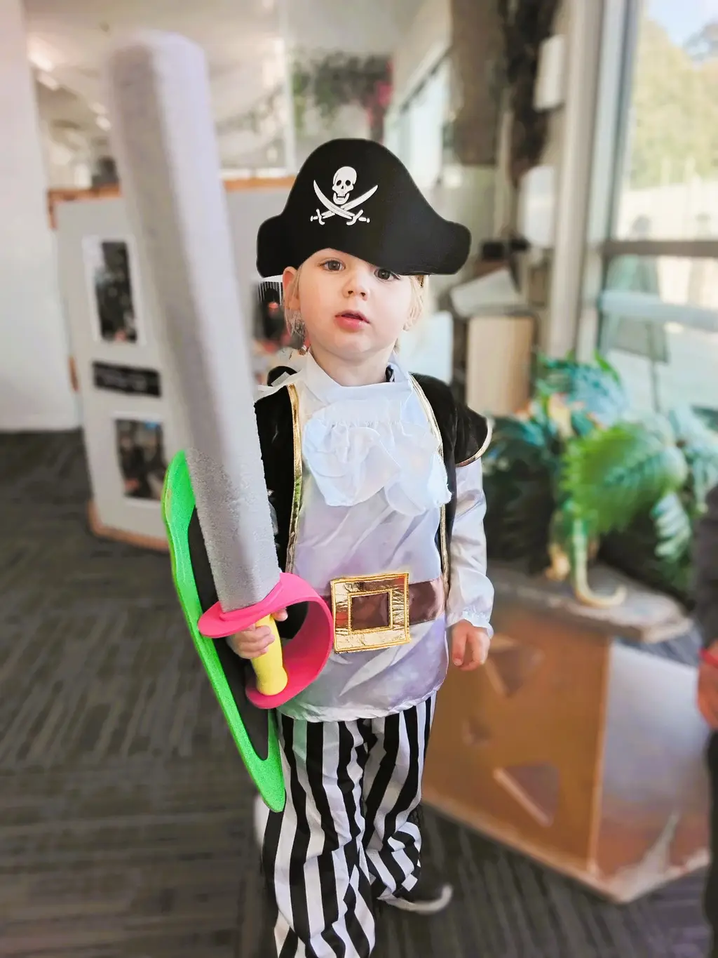 Child exploring dress-up play in a pirate costume